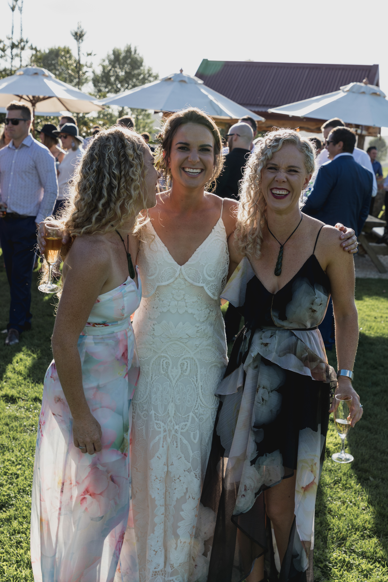 wedding-at-the-red-barn-new-zealand-wedding-photographer-twins-laughing-together-with-bride-at-sunset.jpg