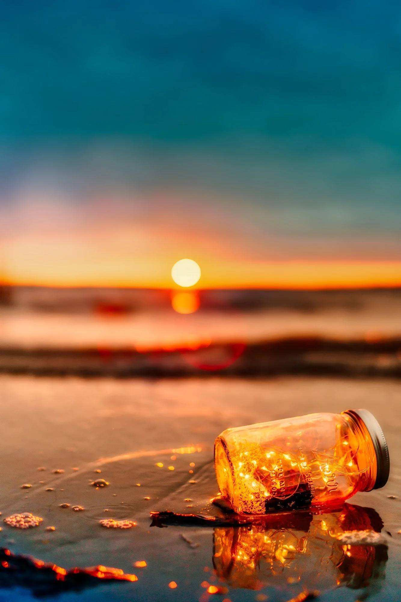 bottle-with-ship-on-the-beach-at-sunset resize.jpg