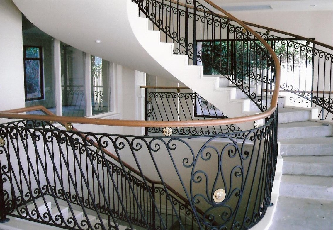 14 - Timber handrail on curved wrought-iron staircase.jpg
