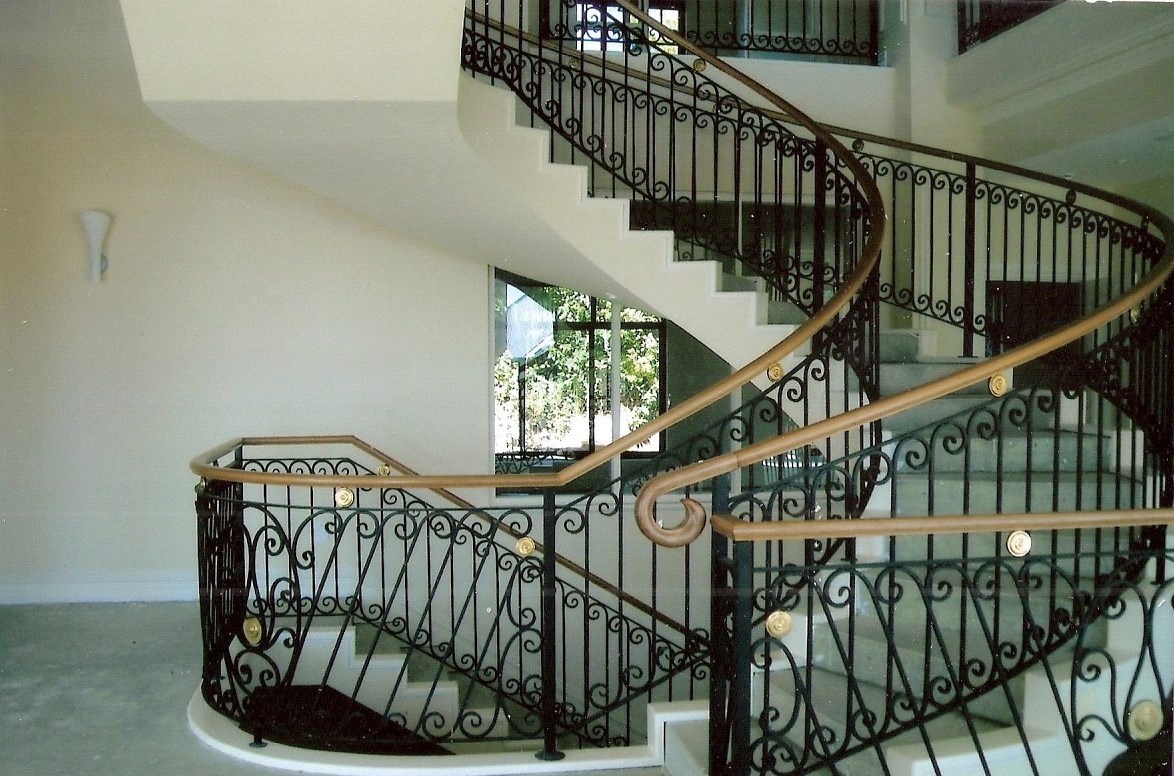 13 - Timber handrail on curved wrought-iron staircase.jpg