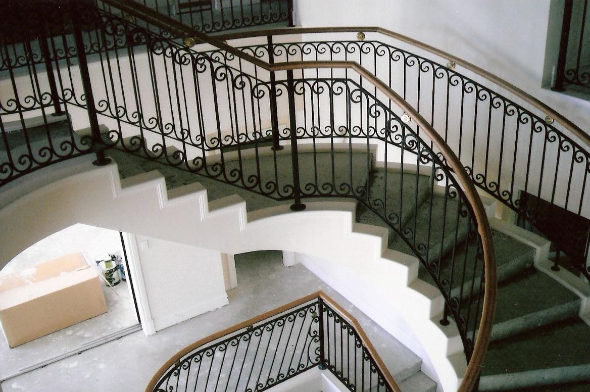 15 - Timber handrail on curved wrought-iron staircase.jpg