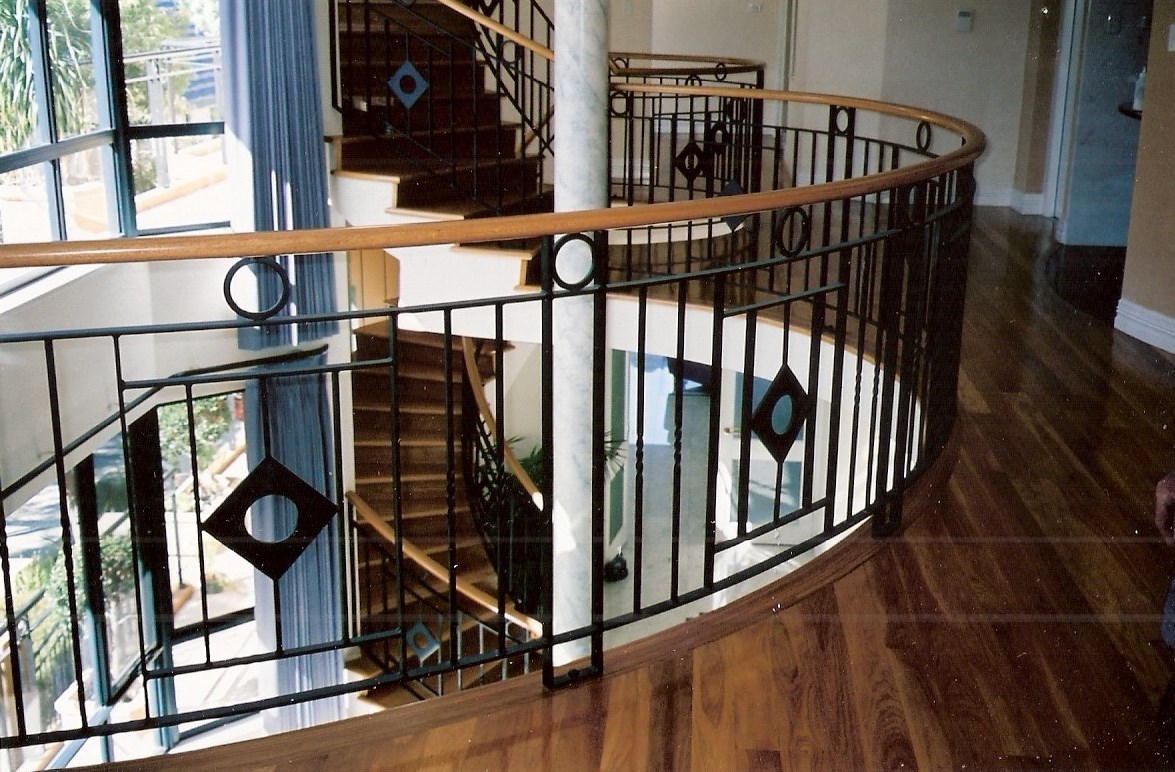 9 - Timber treads on cement, timber handrail on curved wrought-iron staircase.jpg