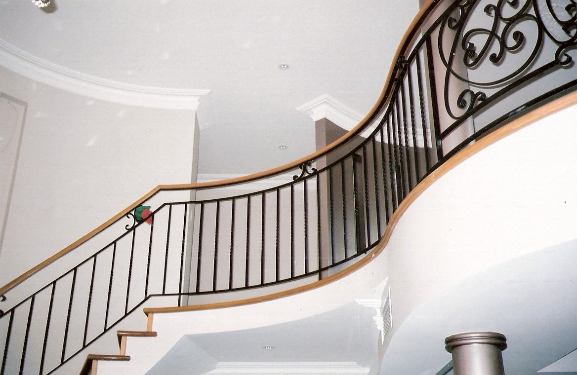 10 - Timber treads on cement, timber handrail on curved wrought-iron staircase.jpg