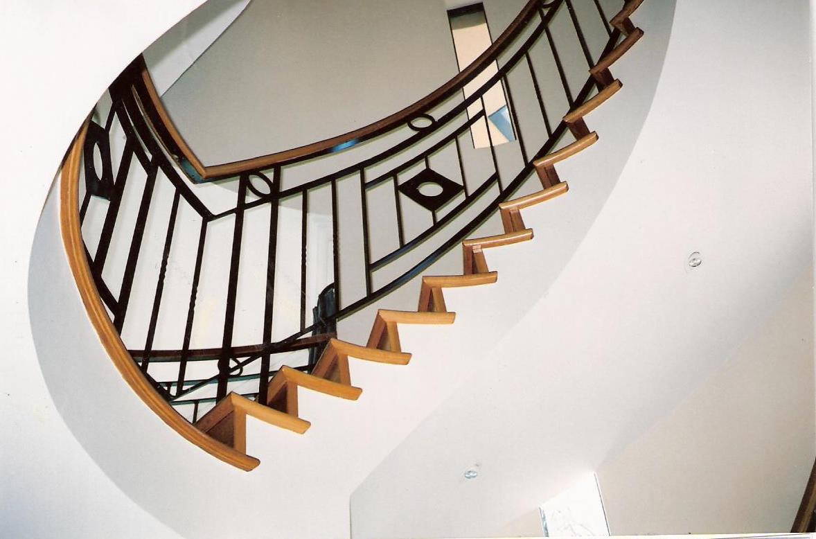 11 - Timber treads on cement, timber handrail on curved wrought-iron staircase.jpg