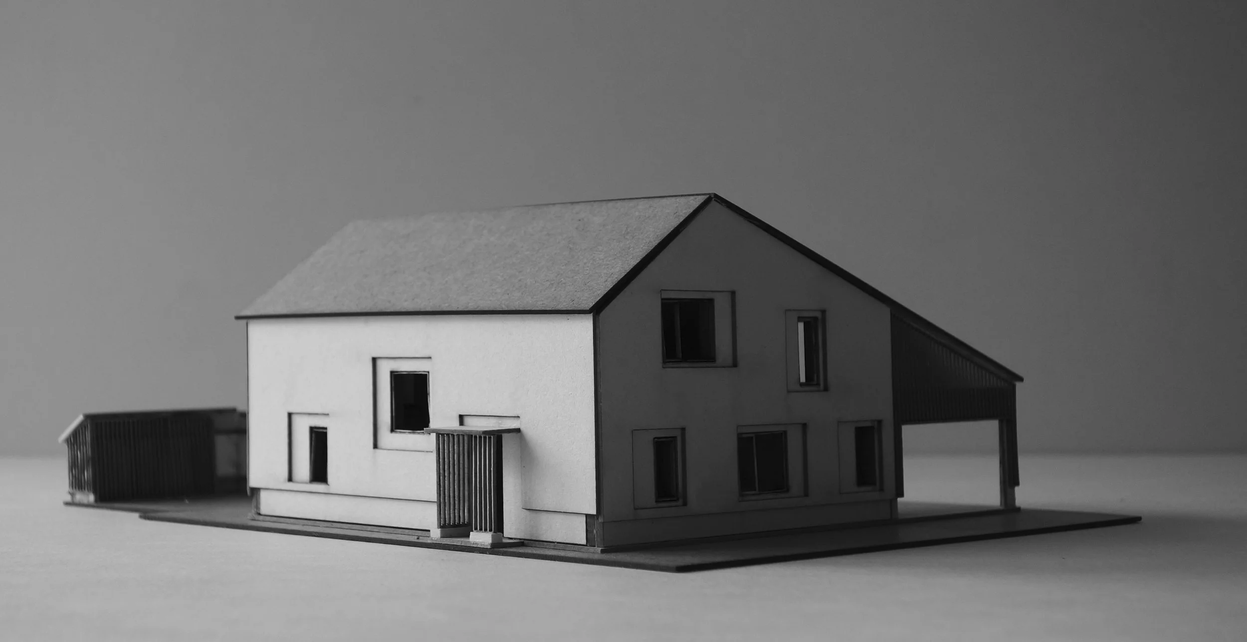  Das Gebäude hat einen L-Förmigen Grundriss. Dieser ergibt sich   1. aus dem etwa dreieckigen bebaubaren Fenster auf dem Grundstück und   2. aus dem Wunsch heraus, hinter dem Haus einen möglichst geschützten Terrassen- bzw. Gartenraum zu schaffen. Ei