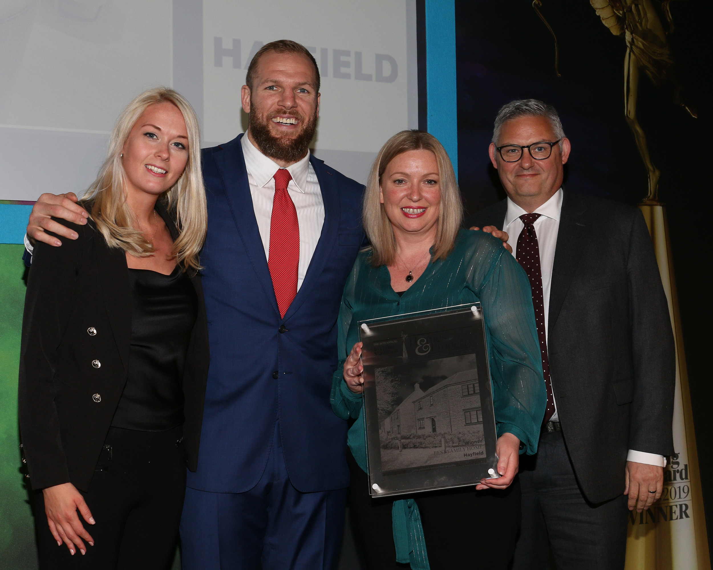 Maddie Robinson, Kelly Sharman and Mark Booth from Hayfield receive the Evening Standard award for Best Family Home from James Haskell.jpg