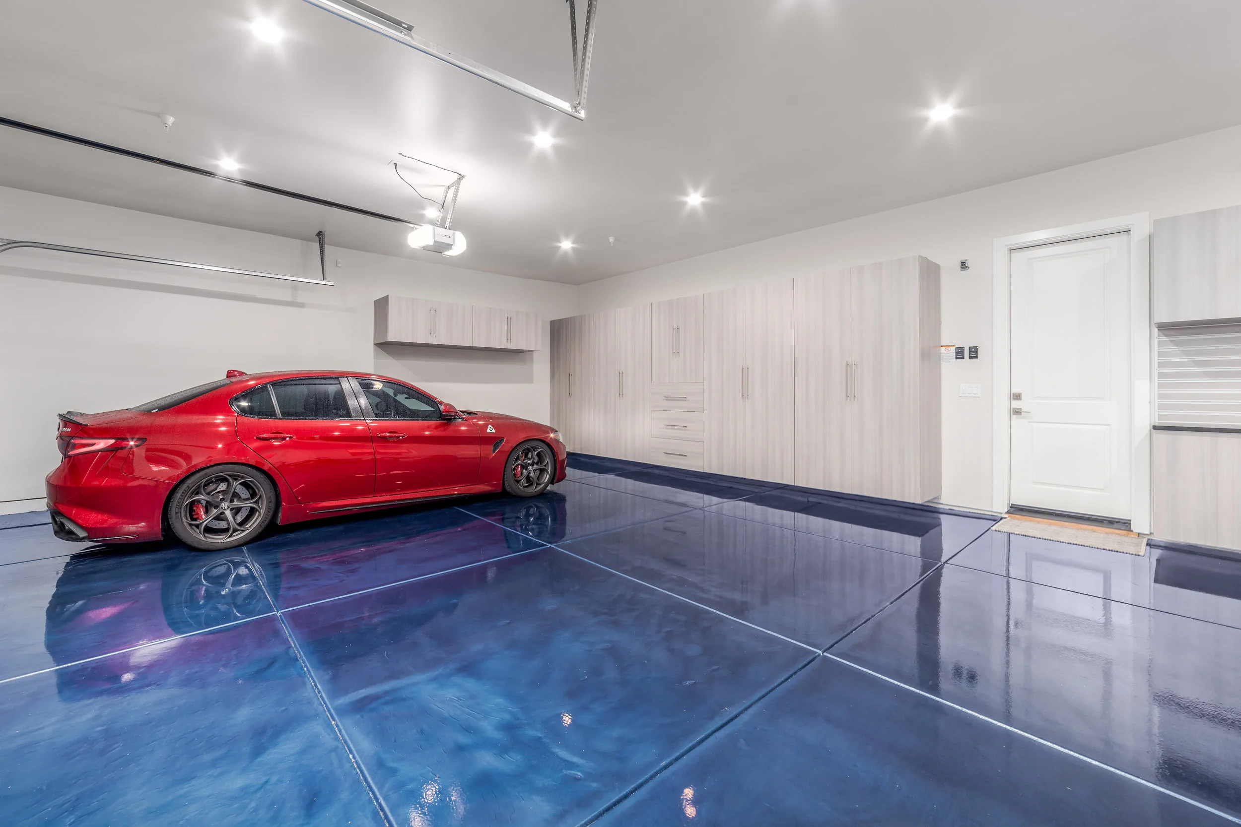 Custom Blue Metallic Epoxy Floor With Cabinets In Folsom