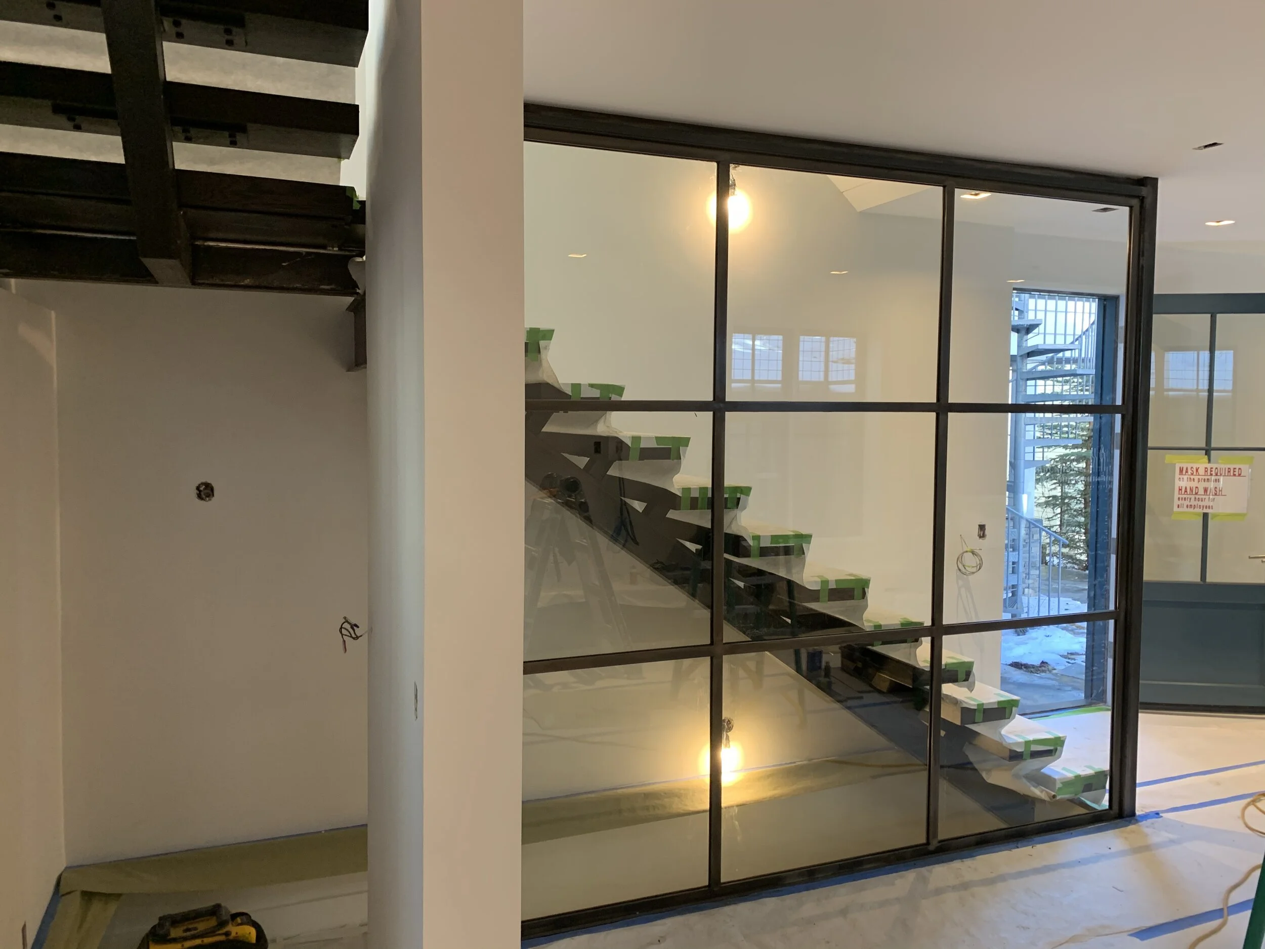 Floating metal stairs and glass wall (Copy)