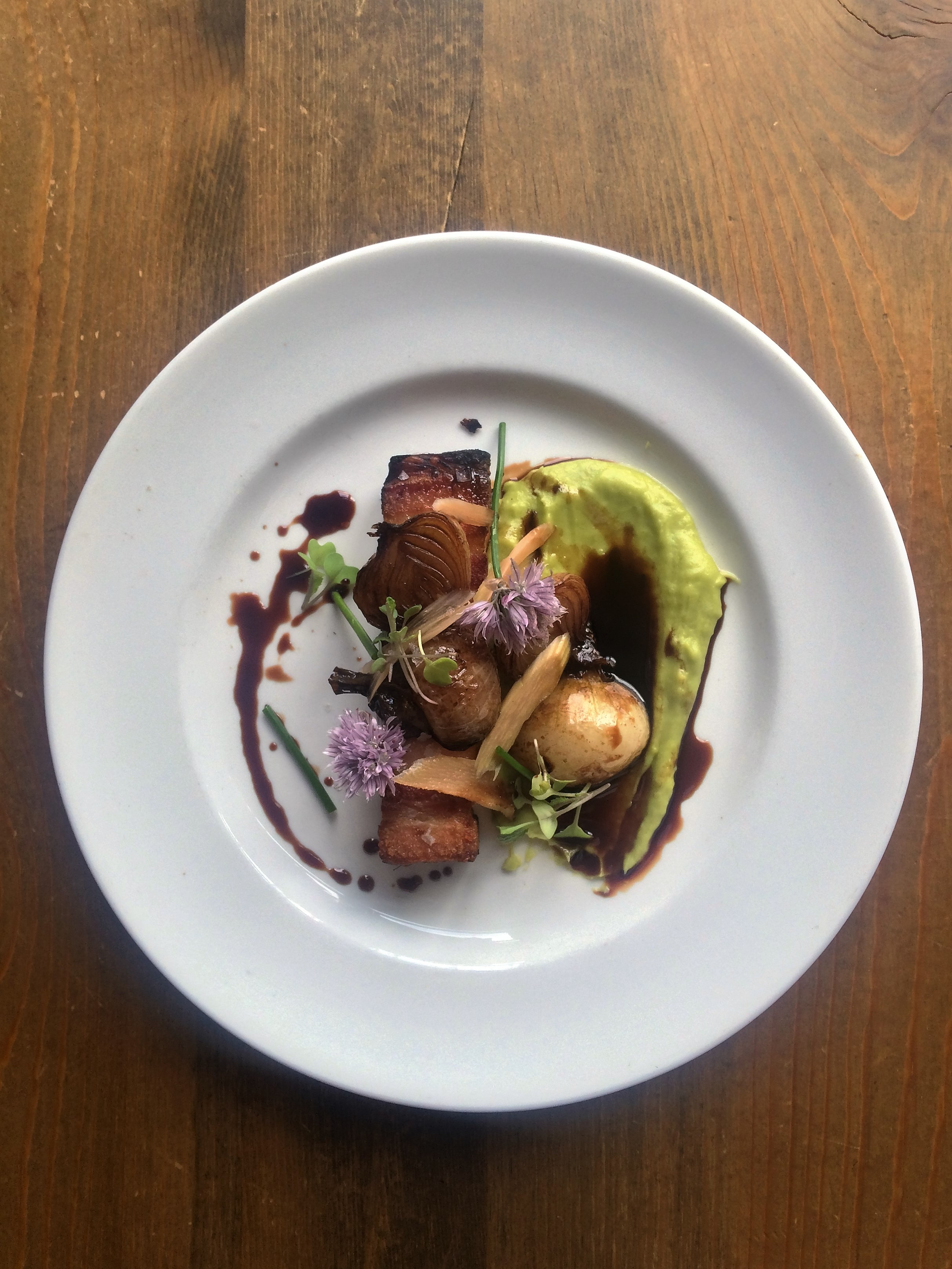 Pork Belly with Fava Bean Puree, Spring Onions, Chive Blossom & Rhubarb Gastrique