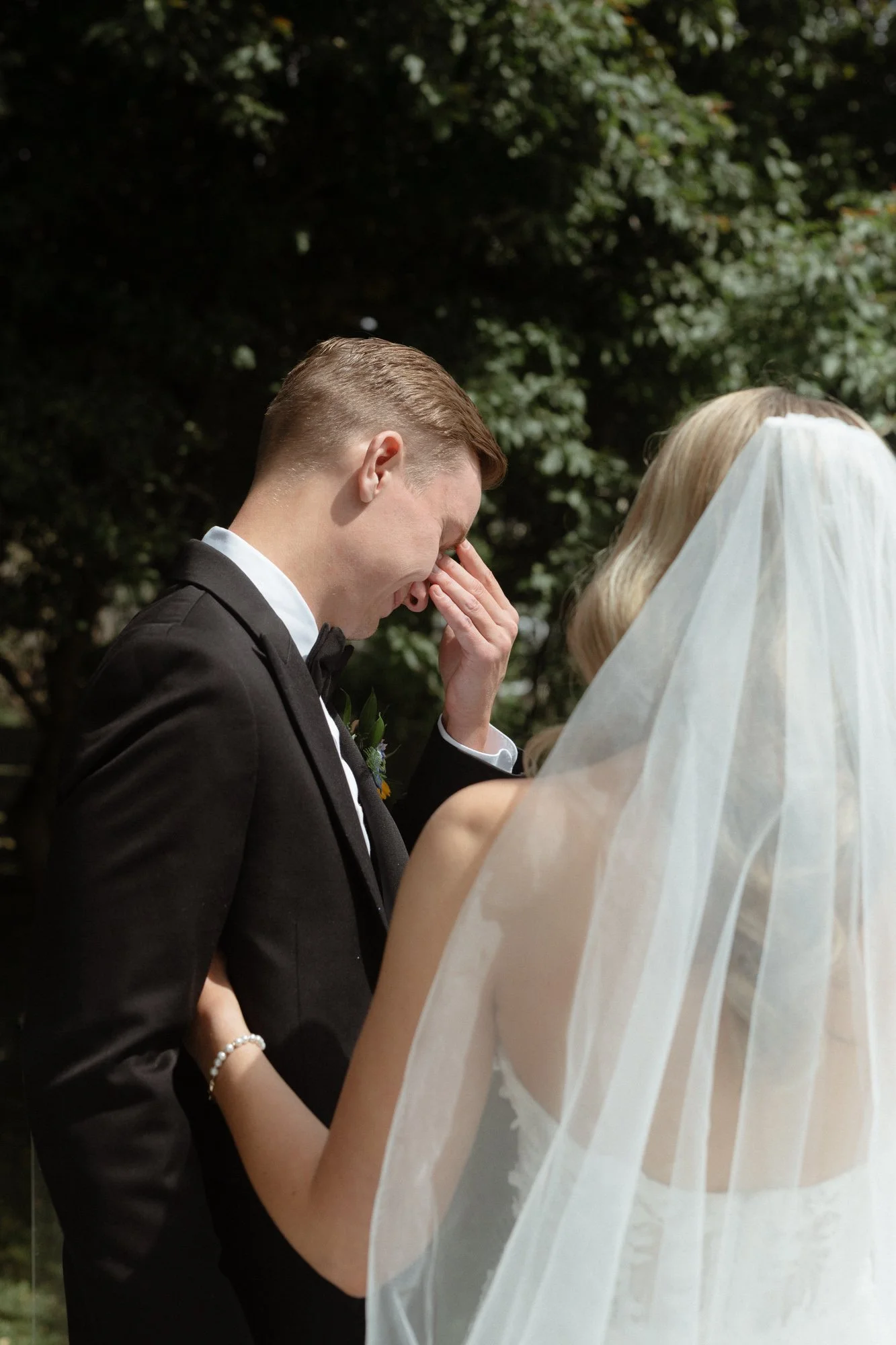 Groom overcome with emotion at first look with veiled bride at Farm at South Cove Nova Scotia
