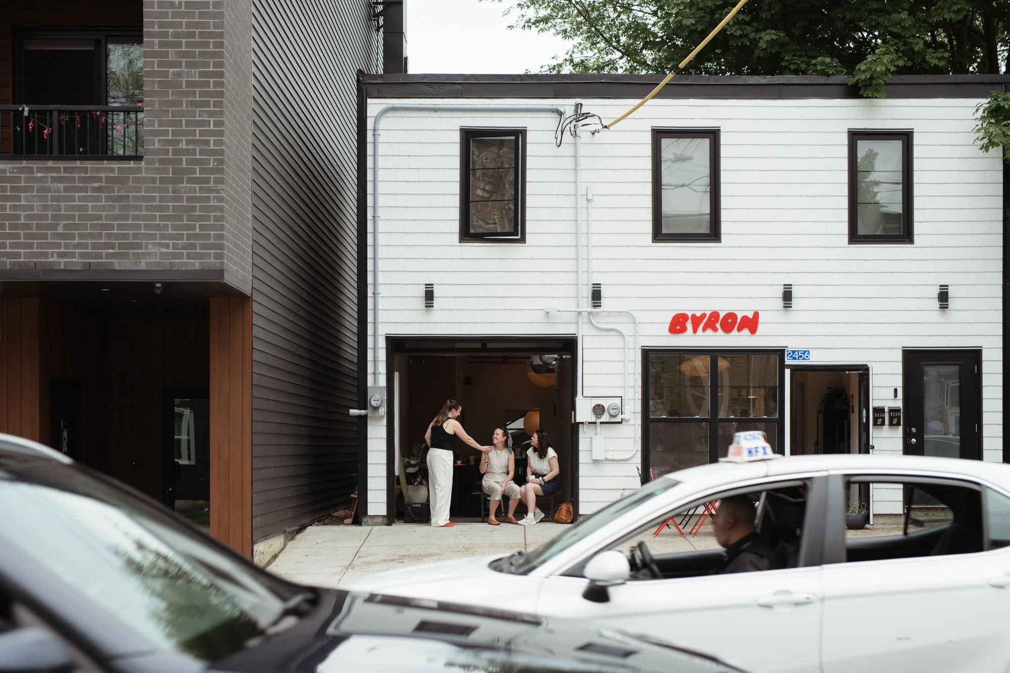 Street scene outside Café Byron Halifax with figures in motion commissioned for Women in Urbanism Canada