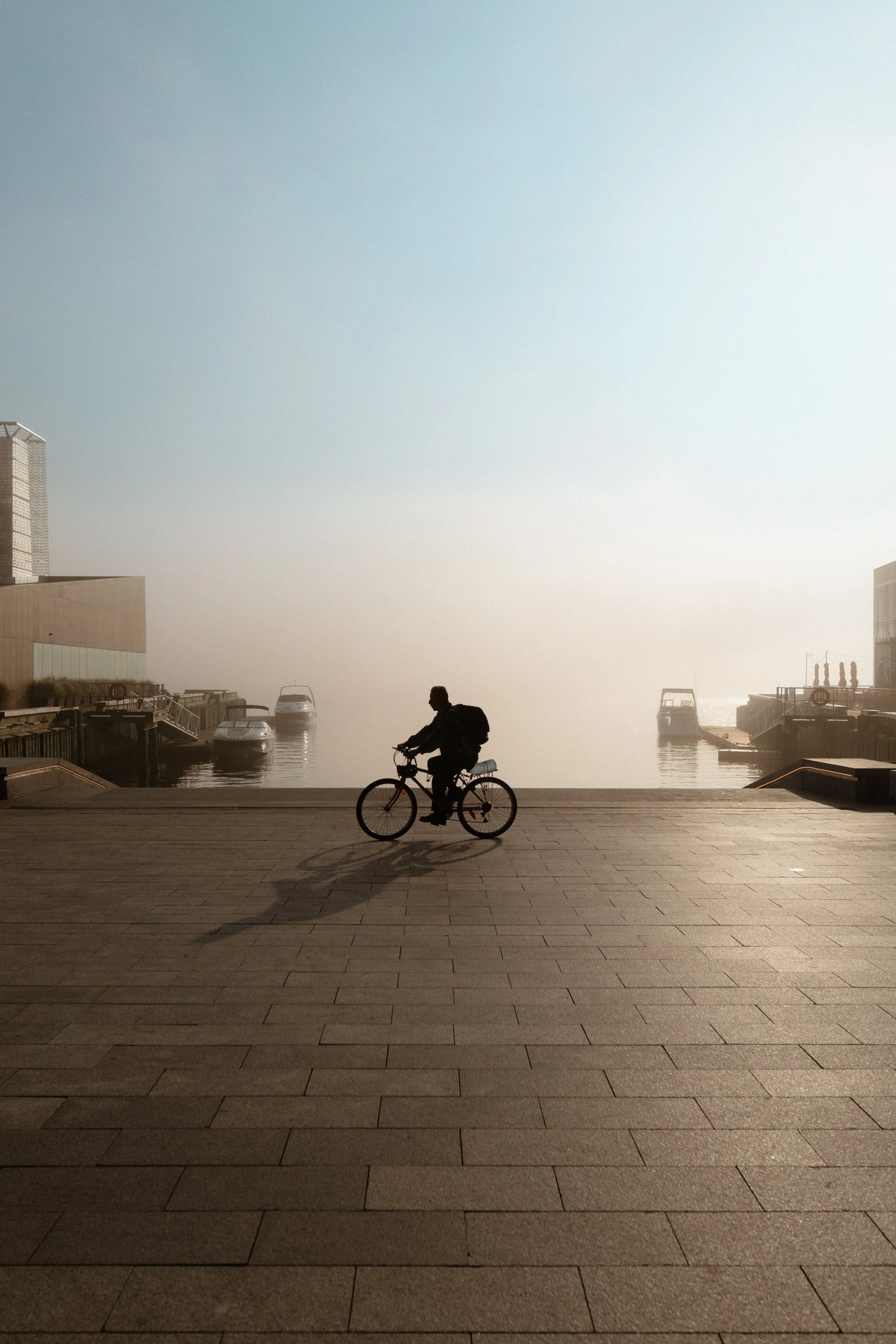 Silhouette of a cyclist on the Halifax waterfront at sunrise