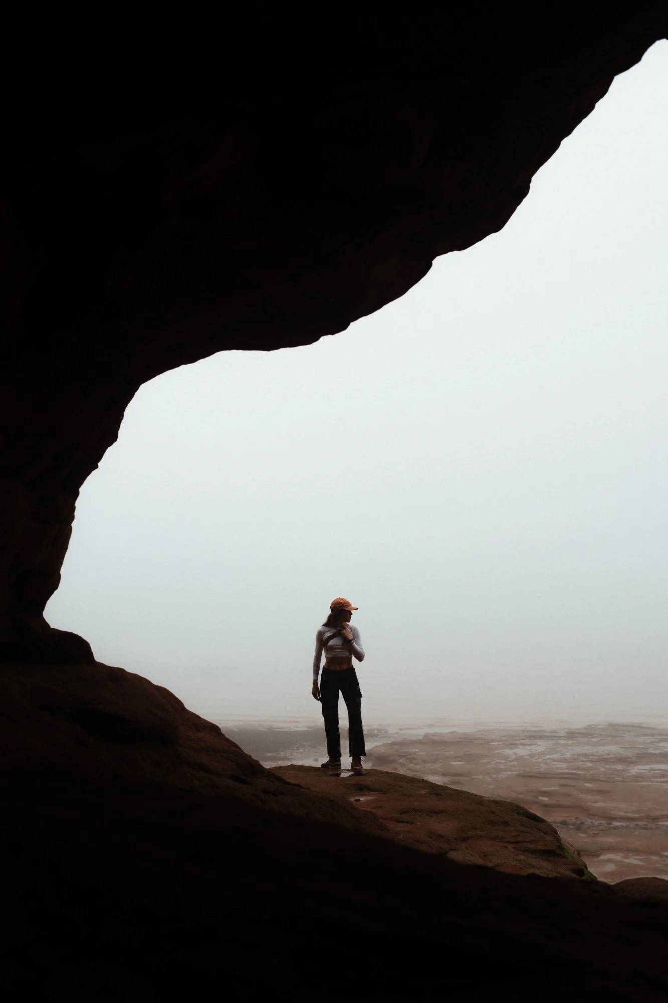 Self portrait of photographer standing in sea cave arch at Burnt Coat Head Bay of Fundy Nova Scotia