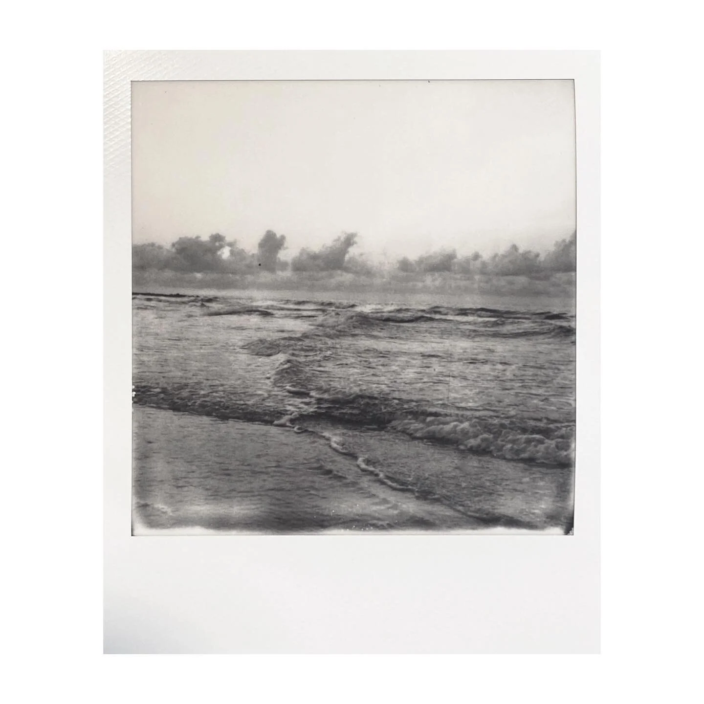 The back reads:
The sleep in our eyes
washed away by the sun rise
and, of course, coffee. 
.
#mypolaroidnow #polaroid #sx70 #polaroidsx70 #blackandwhite #instantfilmsociety #filmisnotdead #instantfilm #instantfilmphotography #beach #sunrise