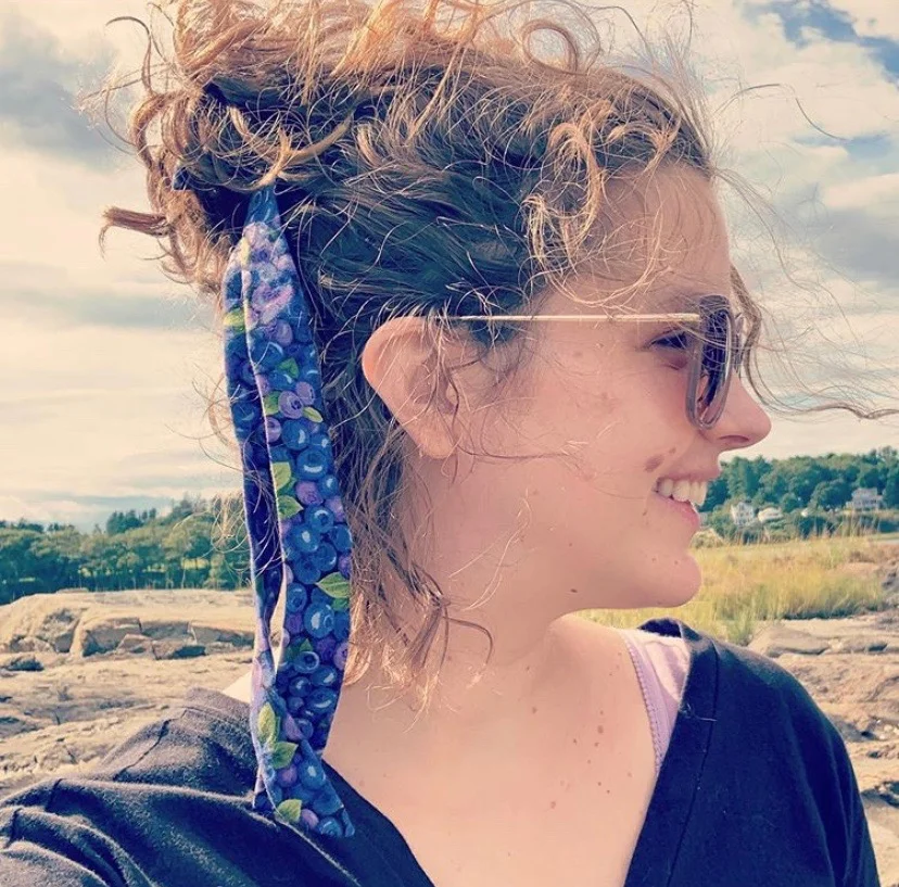 Bethie wearing one of the long bow scrunchies in blueberry print