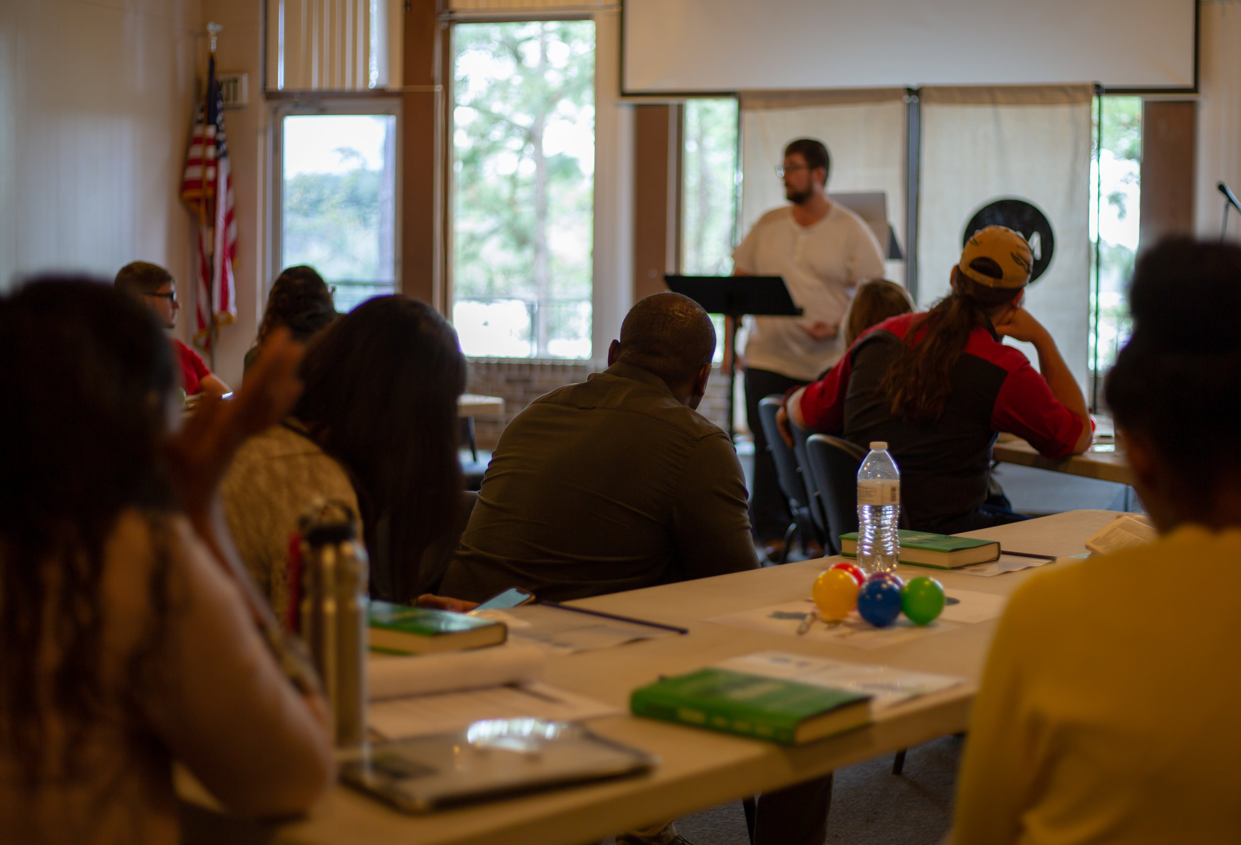 By Shane H. “Attendees listen as Rick Woodruff, assistant director of young adult ministries for Gulf States, presents for Sabbath School.”