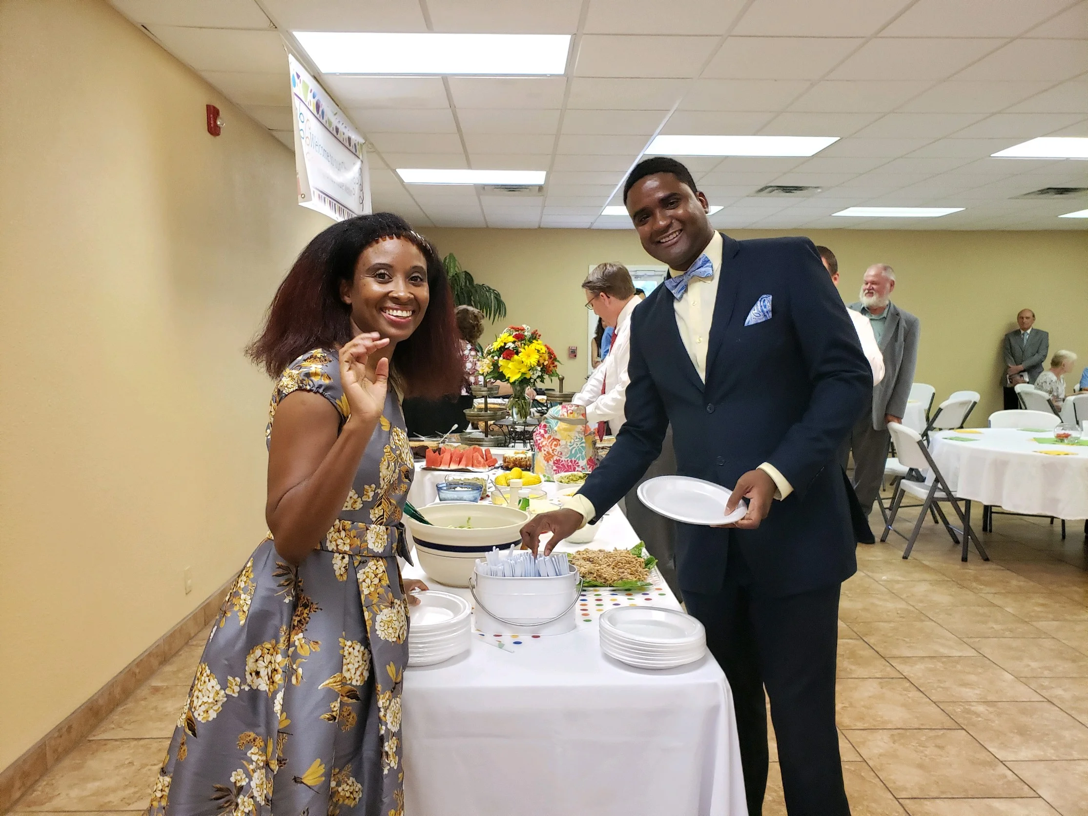 Nicole (left), and Andre Weston partake in the fellowship meal following their installtaion service at Bass Memorial Academy Church in Lumberton, Miss.