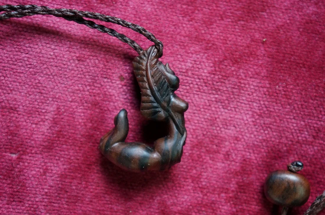 Freedom - 5 cm x 3.5 cm Teak wood pendant on a hand braided cord  SOLD