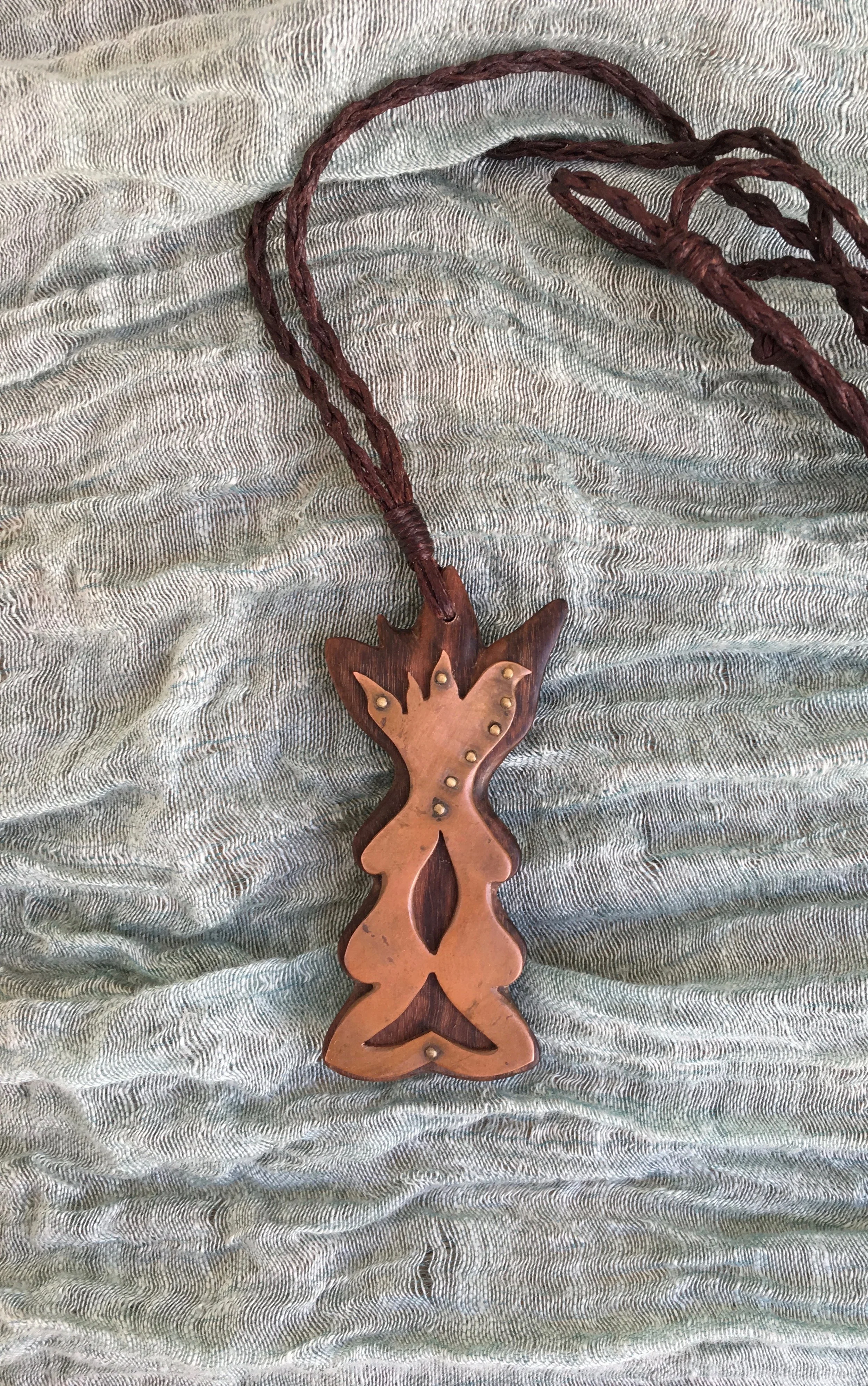 Mirror - Chatham Island Akeake wood and bronze on wax cord, 2018 (Available at Mahara Gallery)