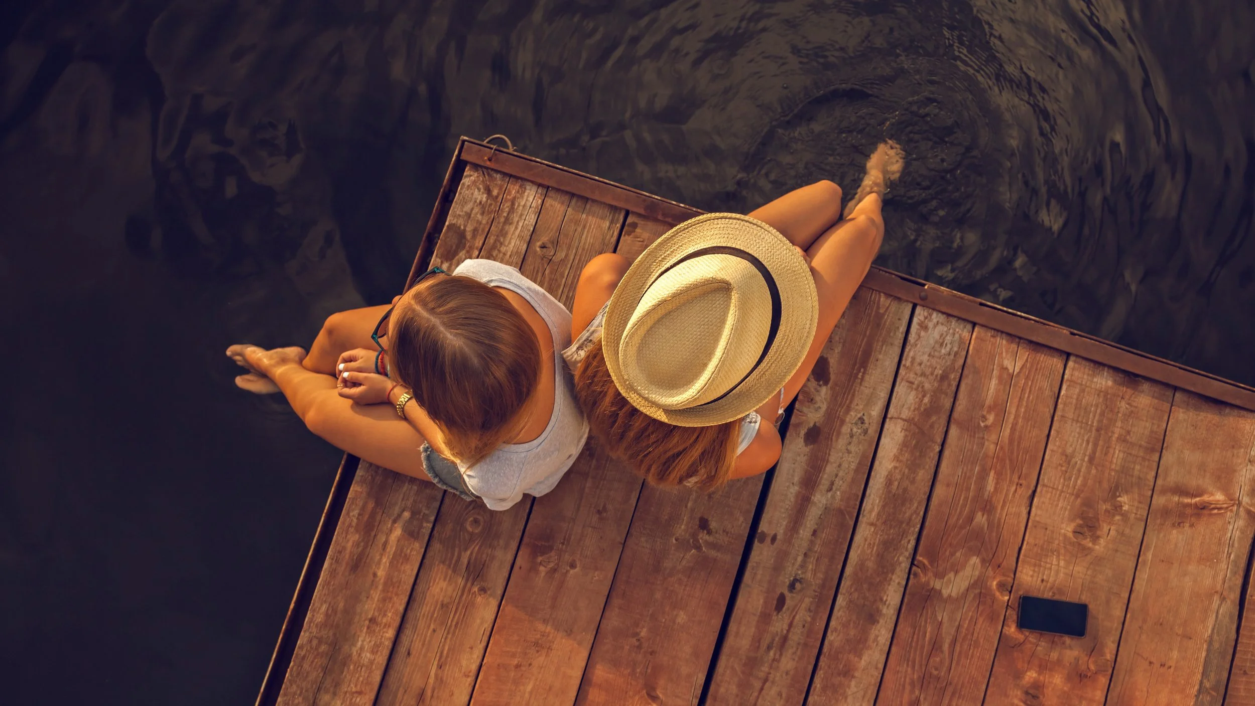 2 girls sitting on dock-squashed.jpg