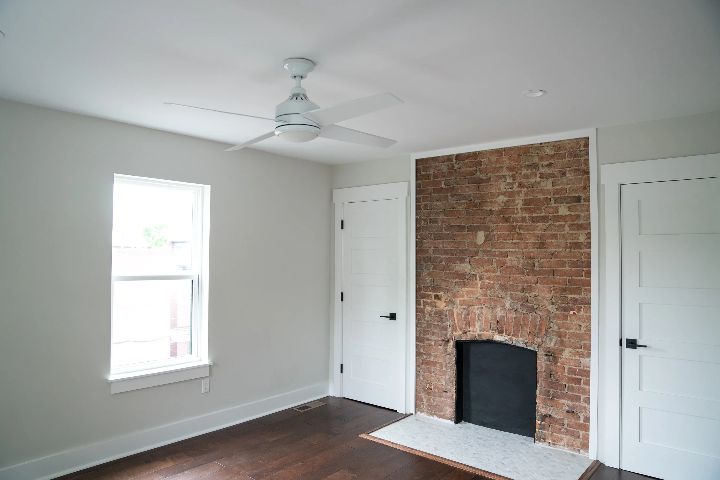 After: in the bedroom, closets were added on either side of the fireplace for storage that appears to be original.