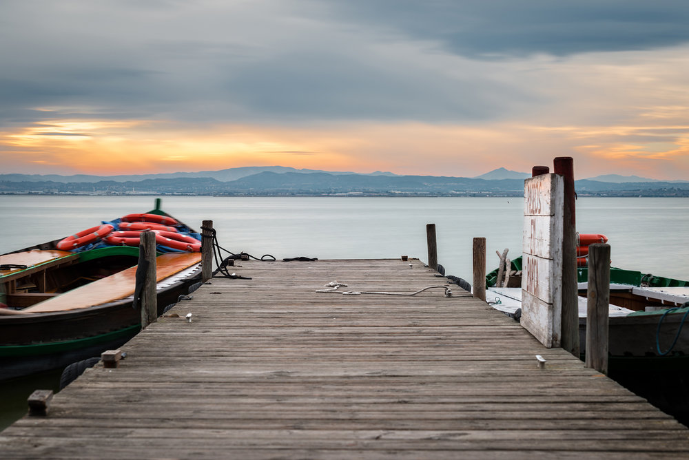 Jetty and small wooden boat at dusk in the Albufera in Valencia