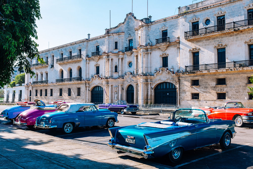 American vintage convertible cars parked by the Luz Caballero park