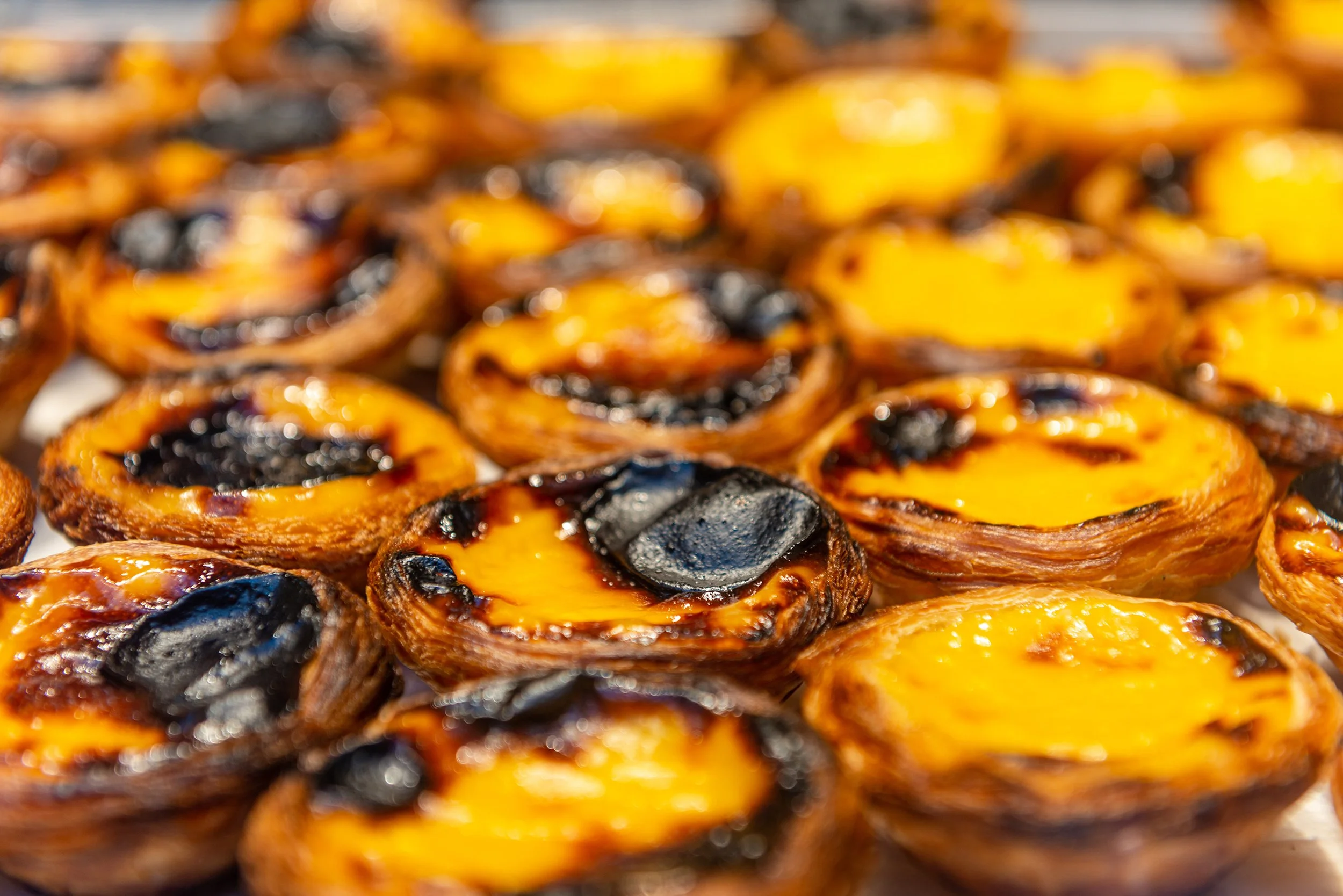 Fresh pasteis de nata (typical Portuguese egg tarts) just backed in a local bakery in Lisbon.
