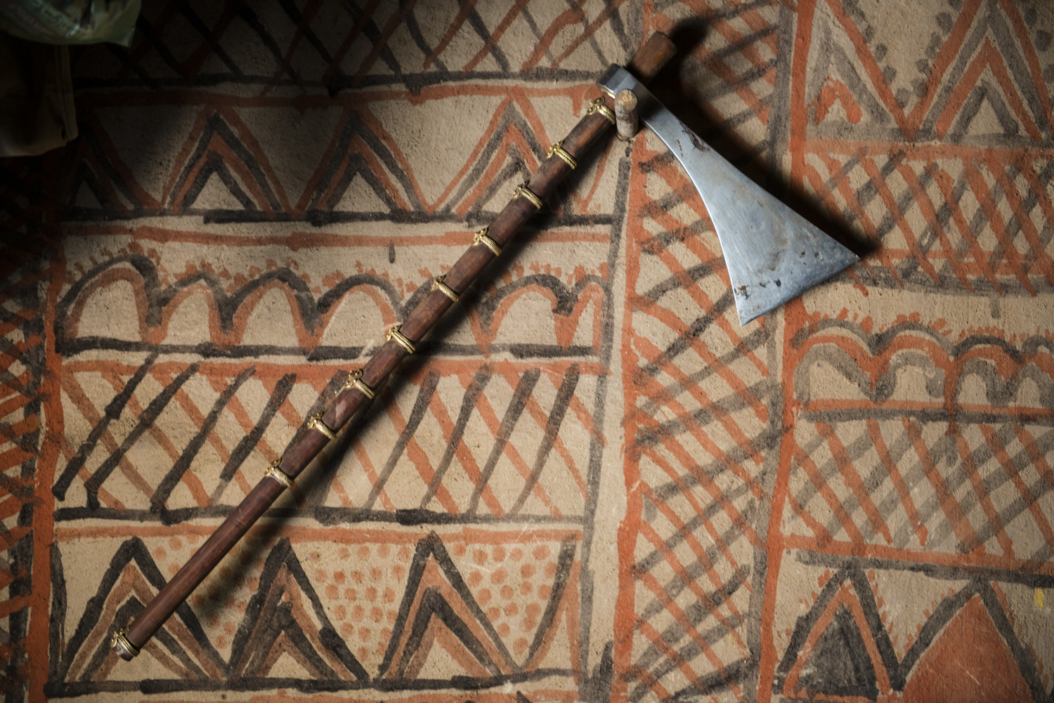 An axe - "tangia" in kui, the kondh dialect - hangs on the interior wall of a kondh house in tahali village, muniguda block, rayagada district. © karan kumar sachdev December 2014.