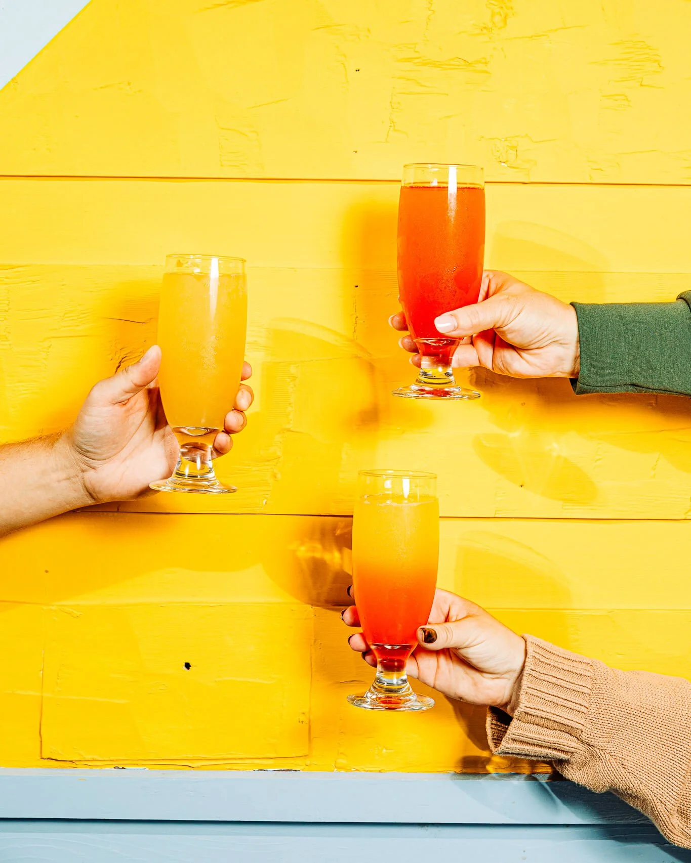 mimosas against a yellow brick wall