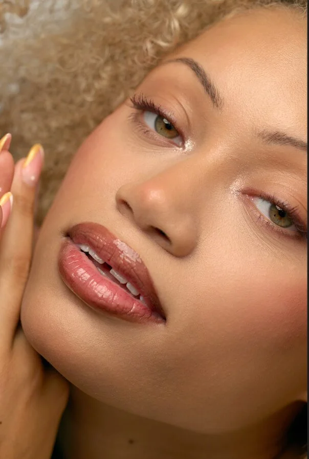 close up picture of a model focusing on lip color and lip gloss beauty products