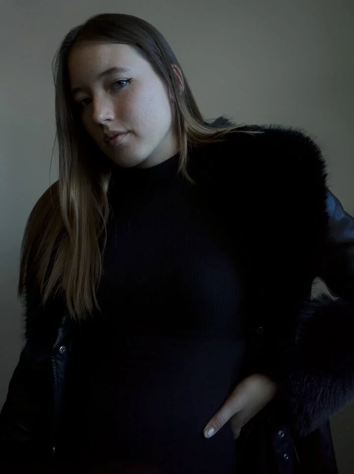 Fashion Model wearing black in the studio with natural lighting
