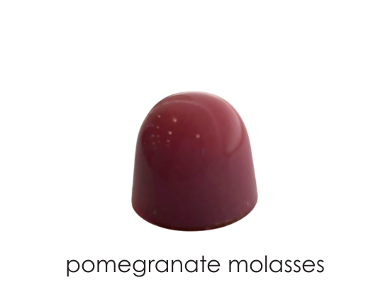 Blonde chocolate ganache with a splash of pomegranate molasses in milk chocolate
