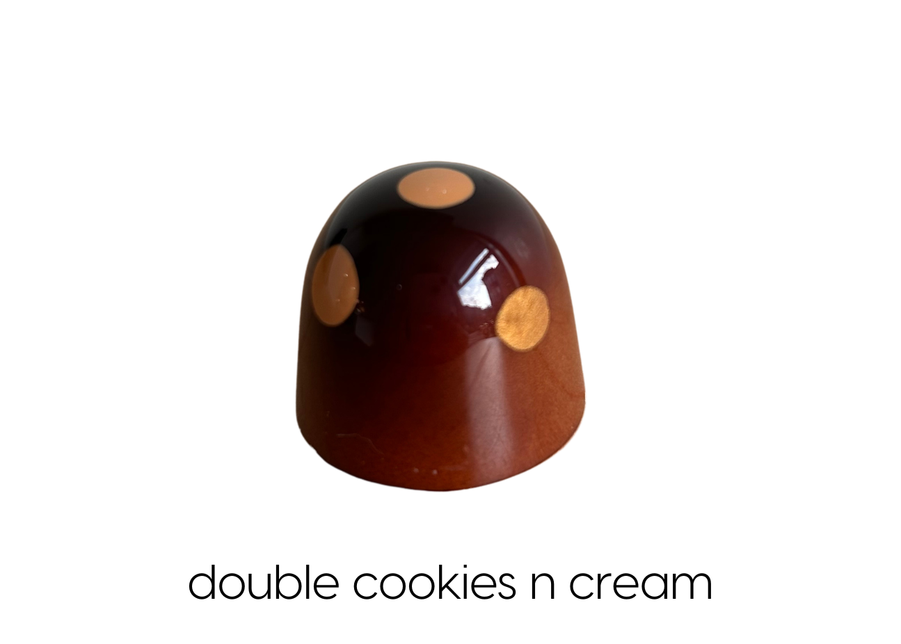 White chocolate ganache with house-made dark chocolate cookie crumbs and a mini cookie in white chocolate 
