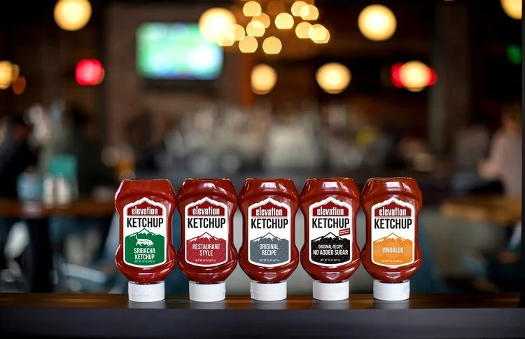 Elevation Organic Ketchup squeeze bottles on a bar top