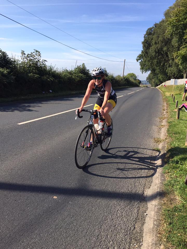  Female Windrush triathlon cycling on road 