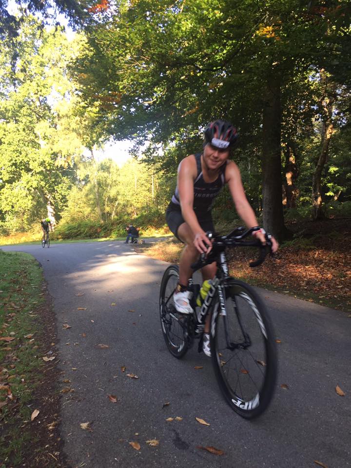  Female Windrush triathlon cycling on road 