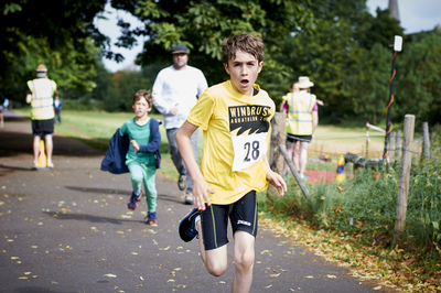  Boy wearing aquathlon tshirt running in Brockwell park 