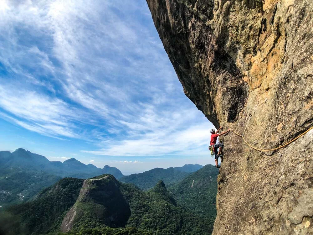 Rock climber on the route Passagem dos Olhos on Pedra da Gavea in Rio de Janeiro, Brazil