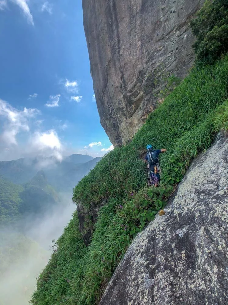 Climber starting the second pitch of the route Passagem dos Olhos