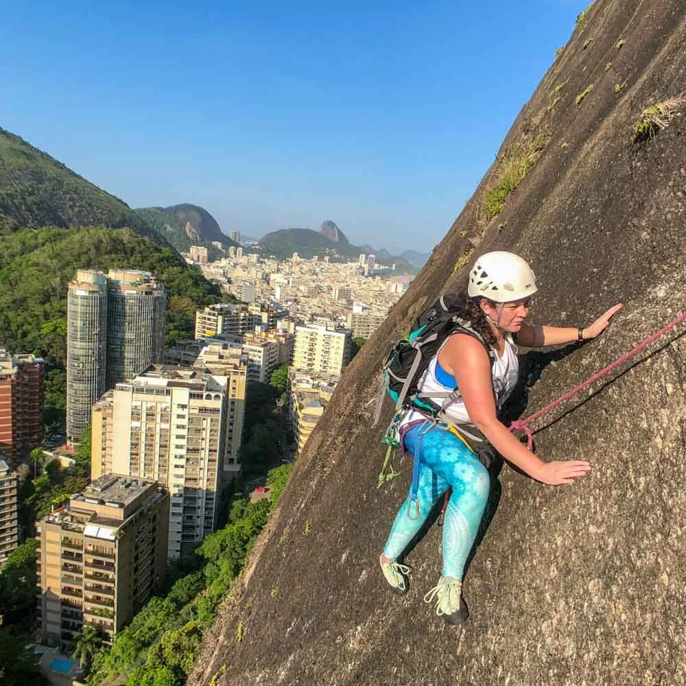 Girl climbing a multi-pitch route on Morro do Cantagalo in Rio de Janeiro