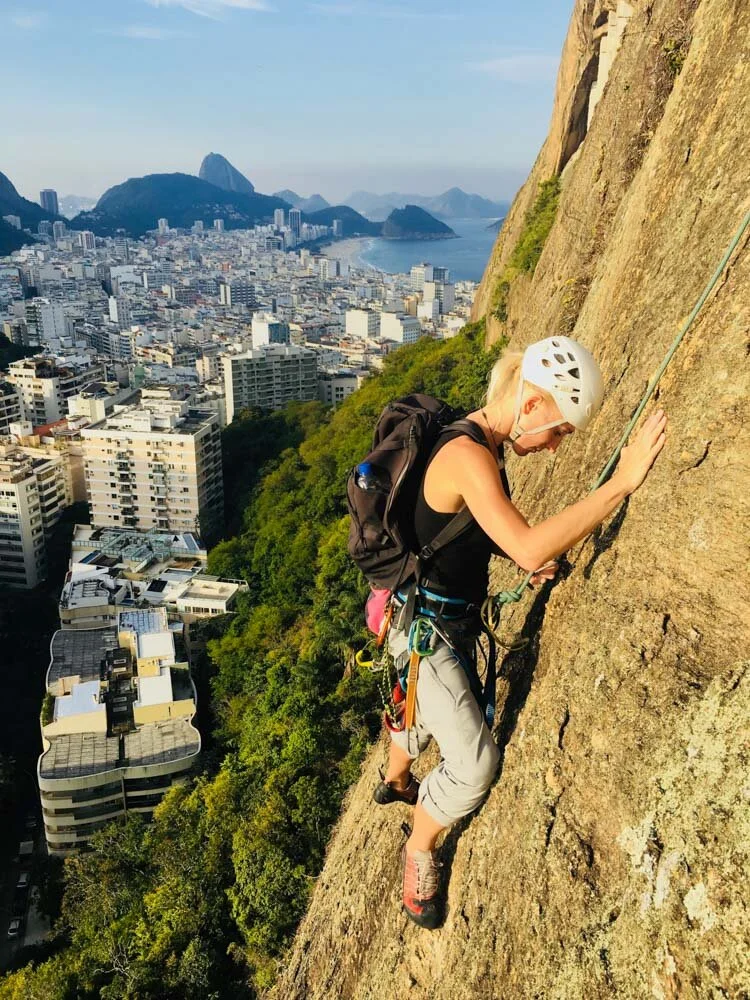 Girl rock climbing on Morro do Cantagalo in Rio de Janeiro