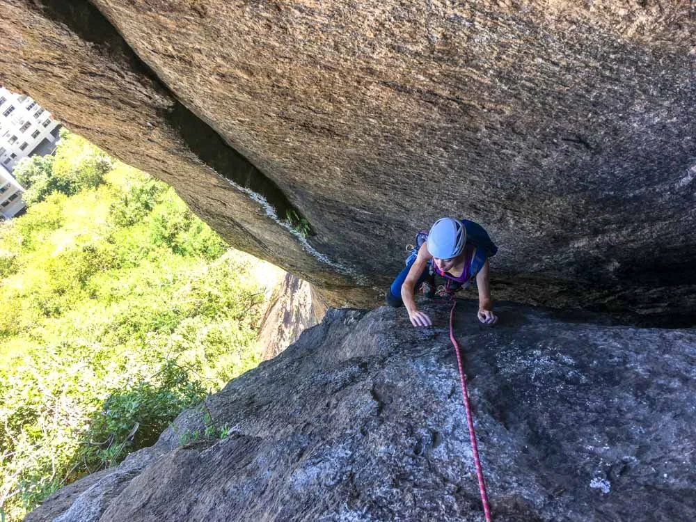 Girl climbing the chimney route Chamine do Prego on Morro do Cantagalo