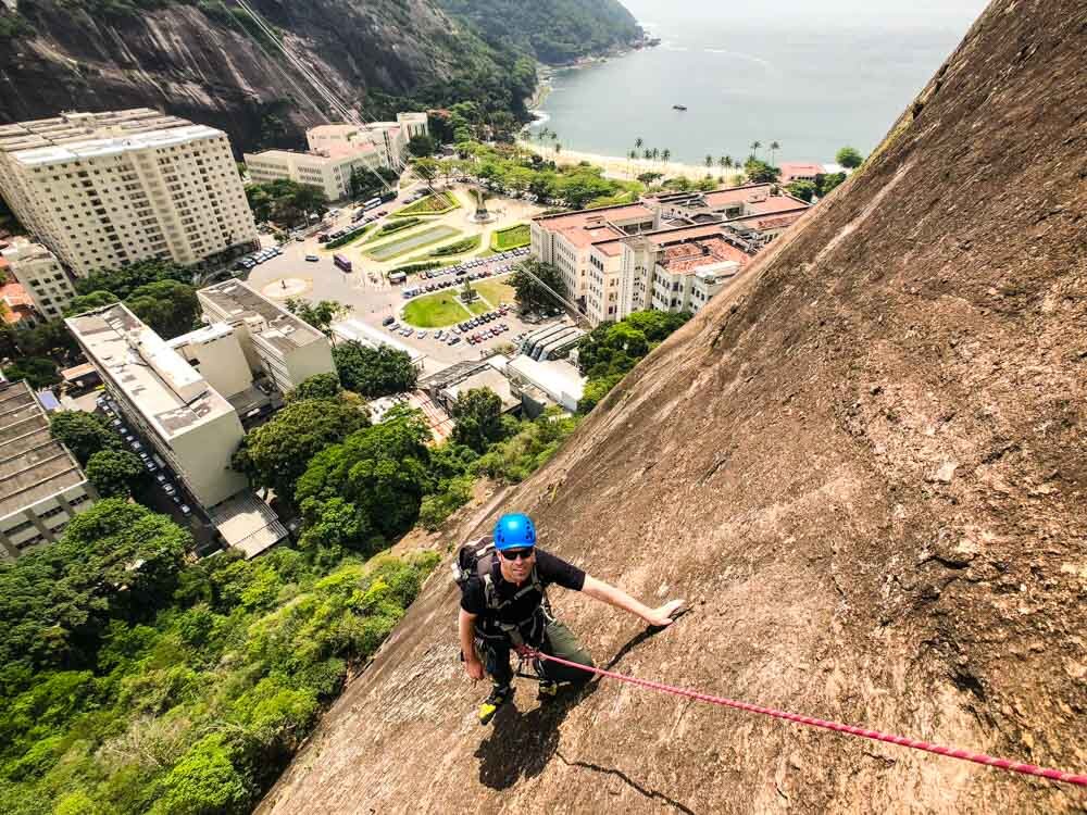 Climber learning multi-pitch rock climbing procedures on Morro da Babilonia in Rio de Janeiro