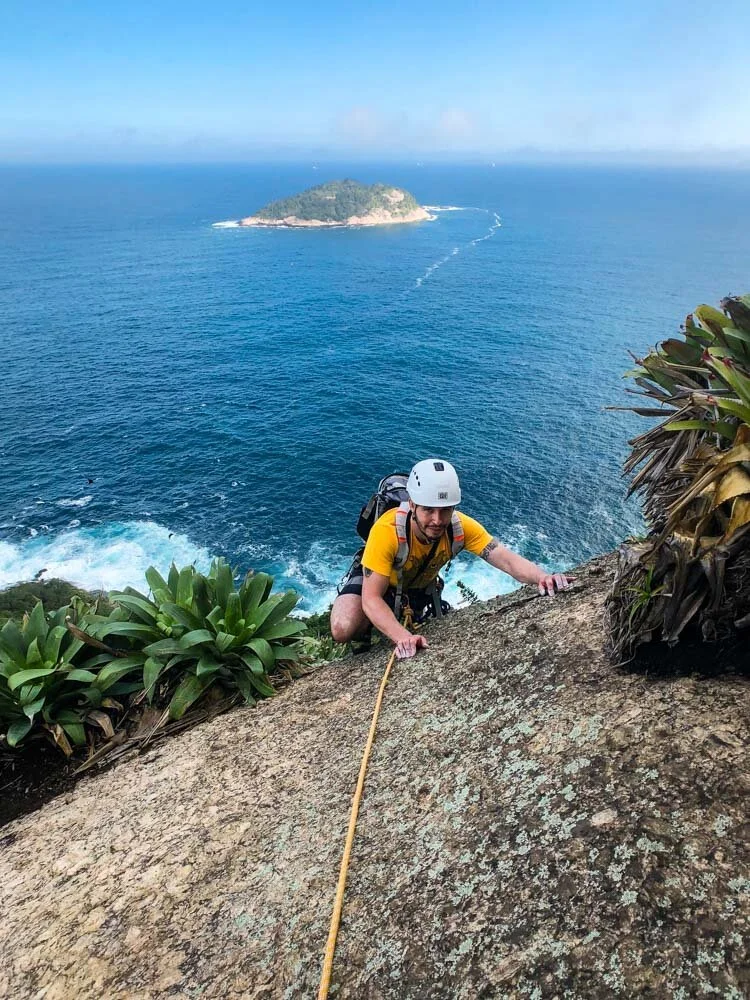 A man climbing on Sugarloaf Mountain during his introductory rock climbing course