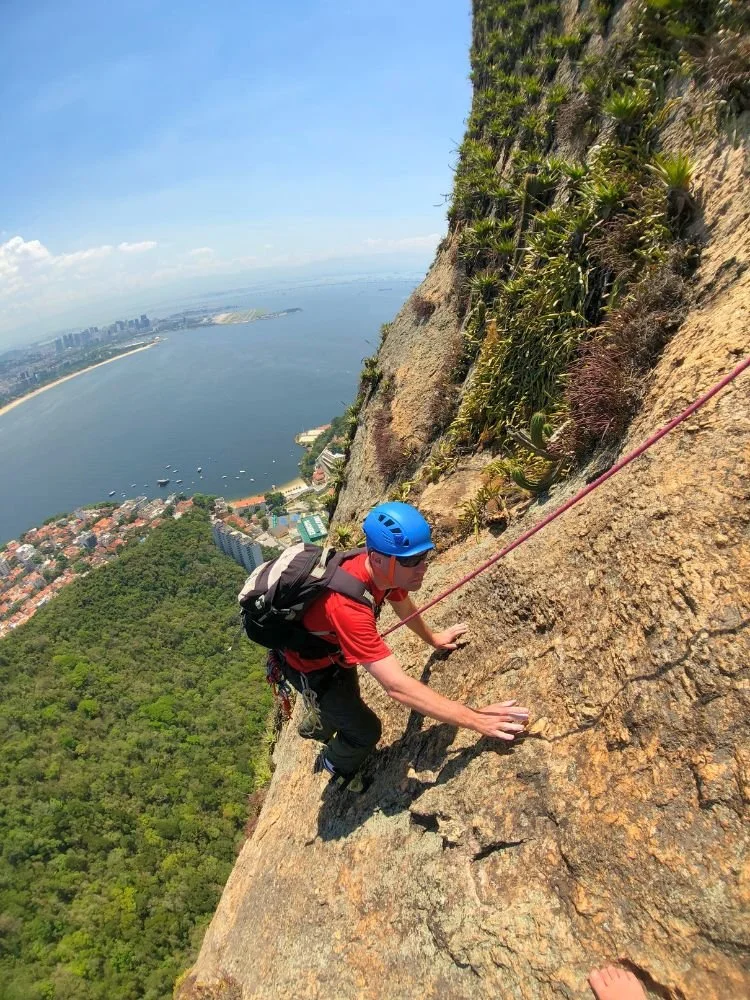 Climber on the classic route Italianos com Secundo on Sugarloaf Mountain in Rio de Janeiro