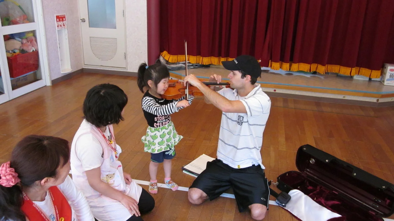 Taking a music break with Hotel Kanyou staff and school teachers