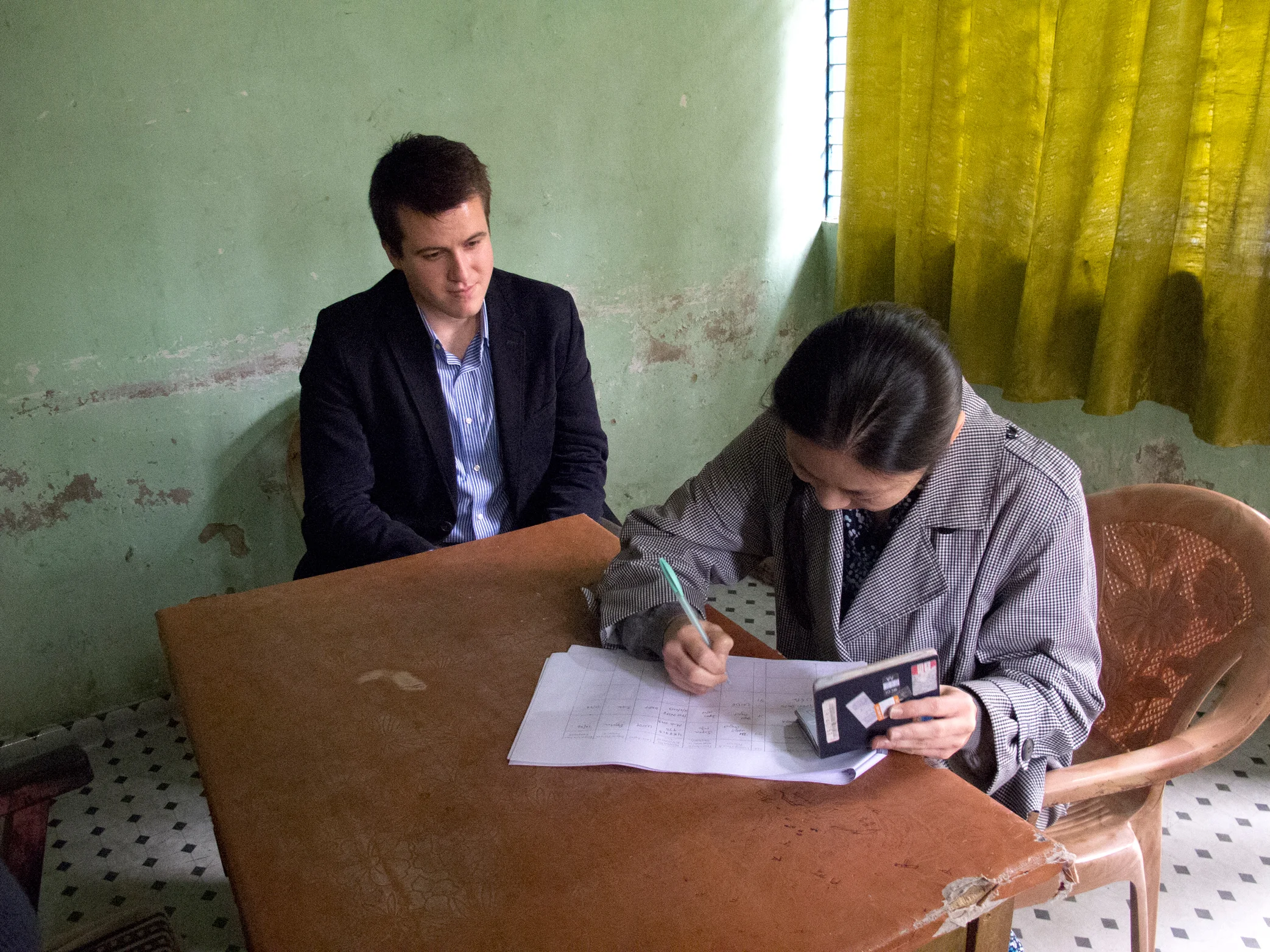 Midori signs in at the CHT military checkpoint with violist Will Frampton. Photo by Shinobu Suzuki.