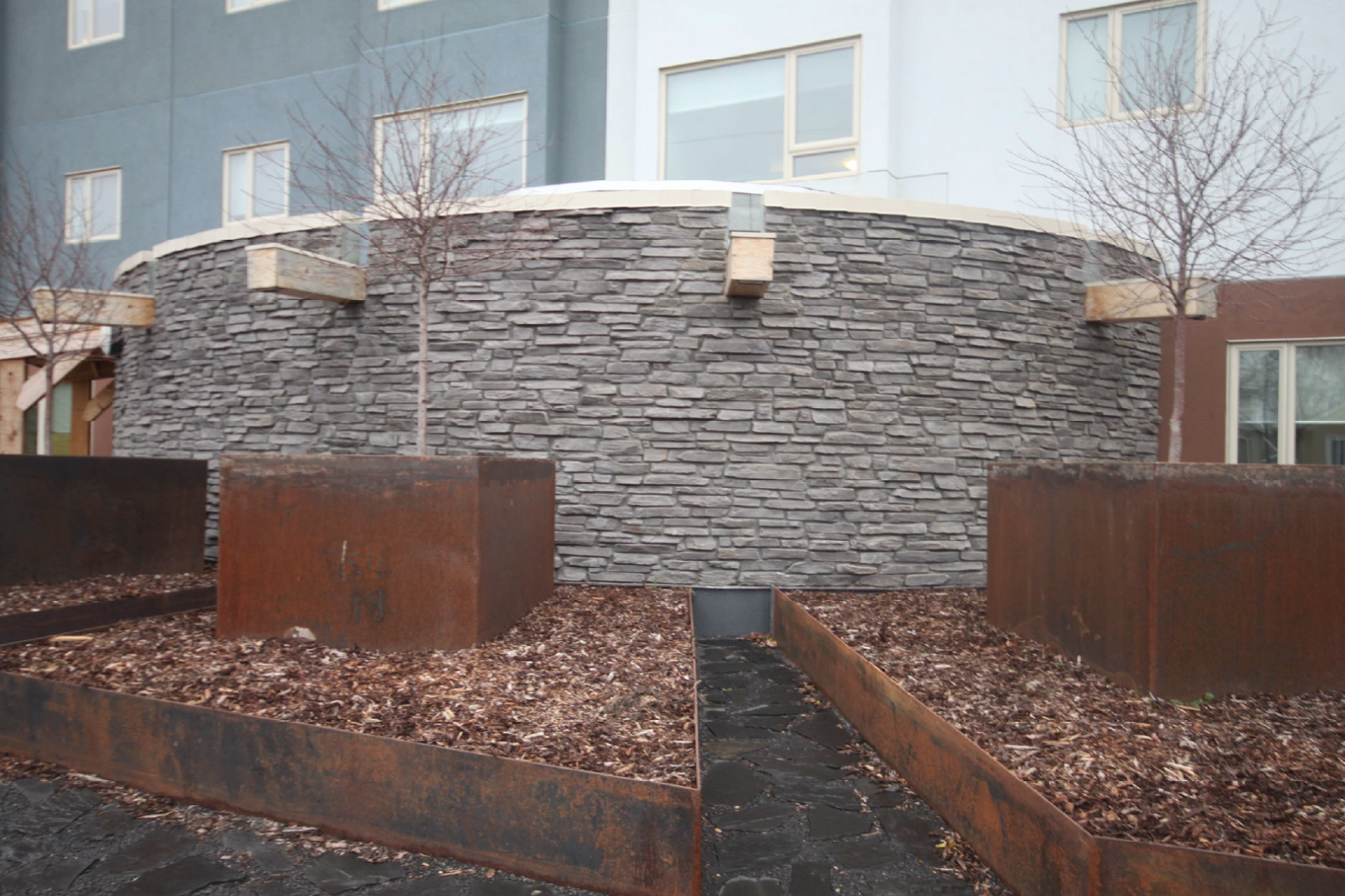 The above images show an exterior view of the Smudging Hut and Landscaping. 