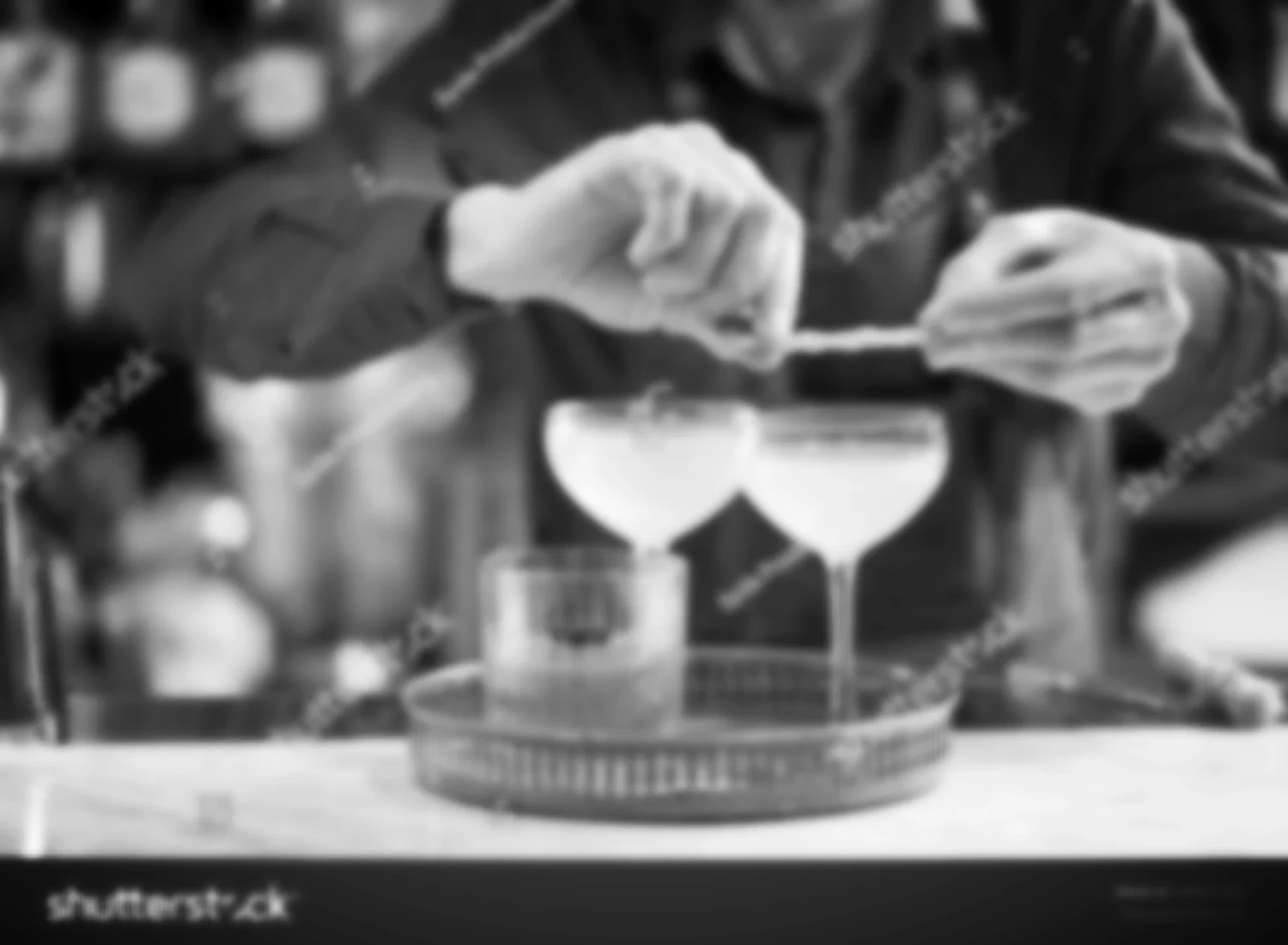 stock-photo-alcohol-drinks-people-and-luxury-concept-bartender-with-glasses-and-lemon-peel-preparing-638077393.jpg